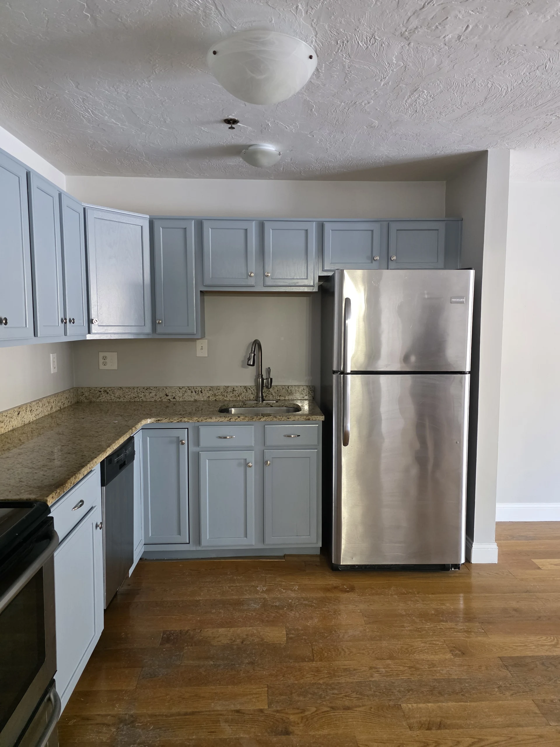 Blue cabinets in an example Foster Place apartment kitchen