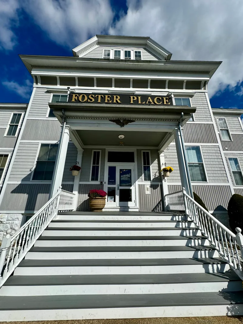 Front entrance of Foster Place, with its gold-lettered sign, white columns and front steps