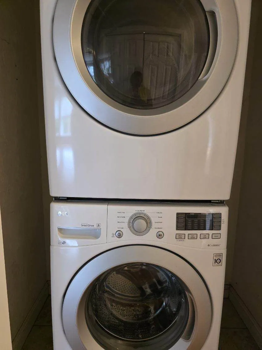A stacked washer and dryer installed in an example apartment