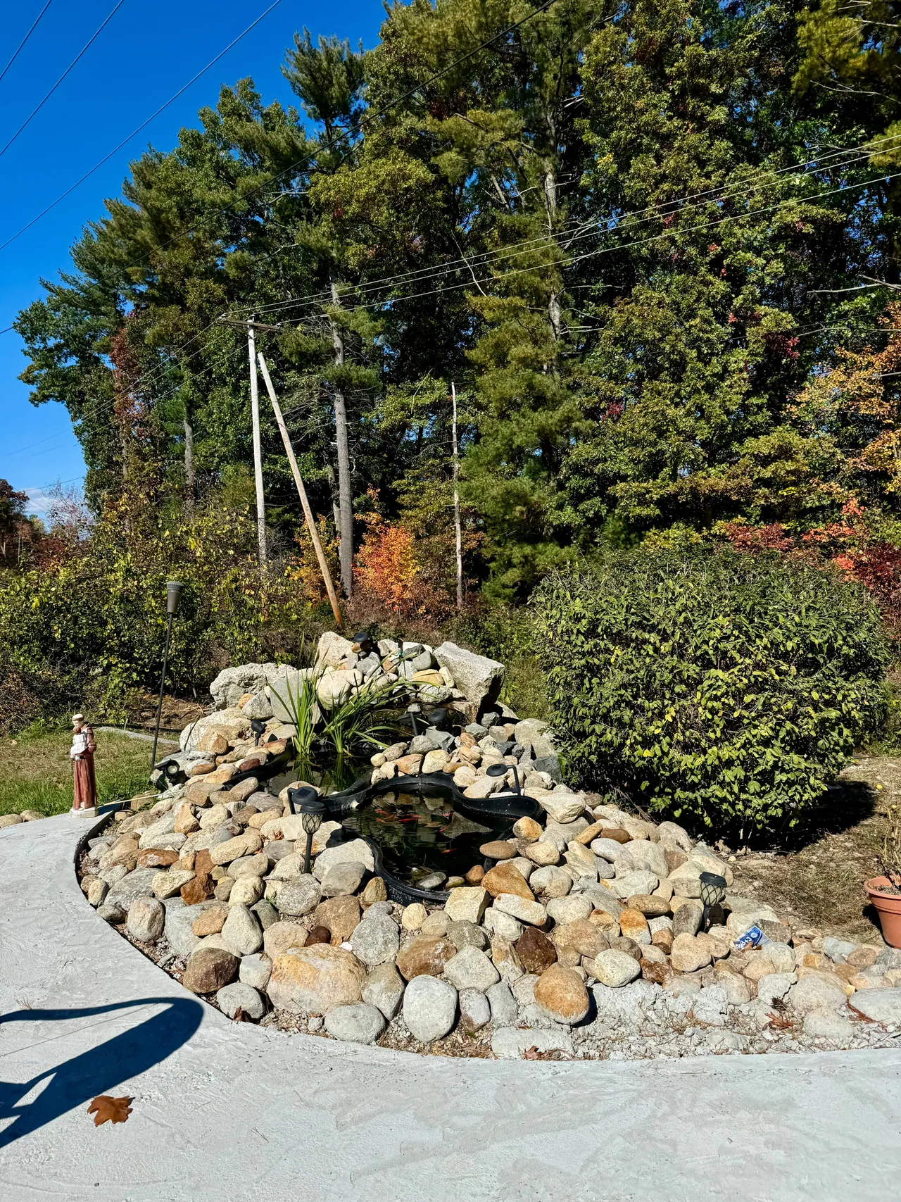 The stone-lined koi pond beside the community patio